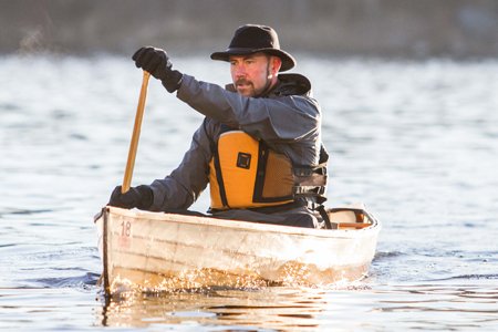 Alexander J. Schad, MD, paddling to work on the Mississippi River. Dr. Schad started going on Boundary Waters trips when he was 7 and today enjoys teaching his kids how to paddle.