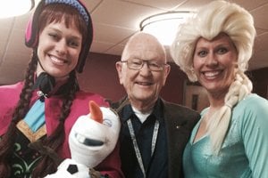 Employees and sisters Andrea and Jessica dressed as Disney Frozen characters, Anna and Elsa, whose costumes brought a whimsical touch to the event enjoyed by all ages; including volunteer, Darwin.