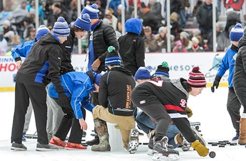 Volunteers from the Sartell Youth Hockey Association entertained fans at Hockey Day Minnesota 2018 with a Chuck a Puck contest with proceeds benefiting the Minnesota Sled Hockey Association.