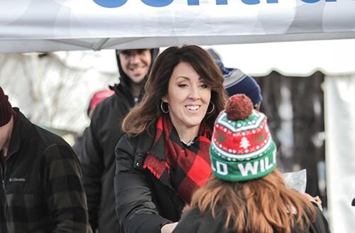 Attendees check out the CentraCare Health and Feeling Good MN tent at the Winter Village, part of the Hockey Day Minnesota festivities.